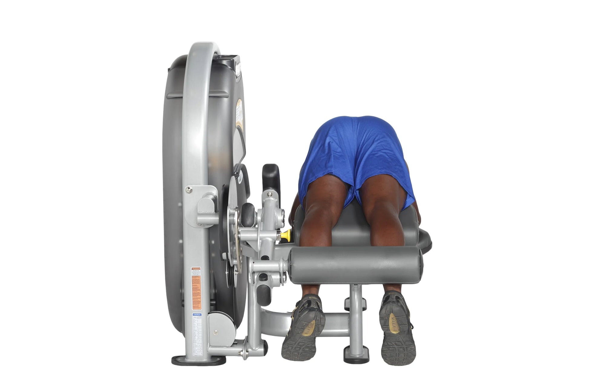 Hoist Standing Prone Leg Curl machine with user in blue shirt demonstrating exercise position on white background