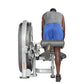Person using gray and silver Hoist Standing/Prone Leg Curl machine, wearing gray tank top and blue shorts, on white backgroun
