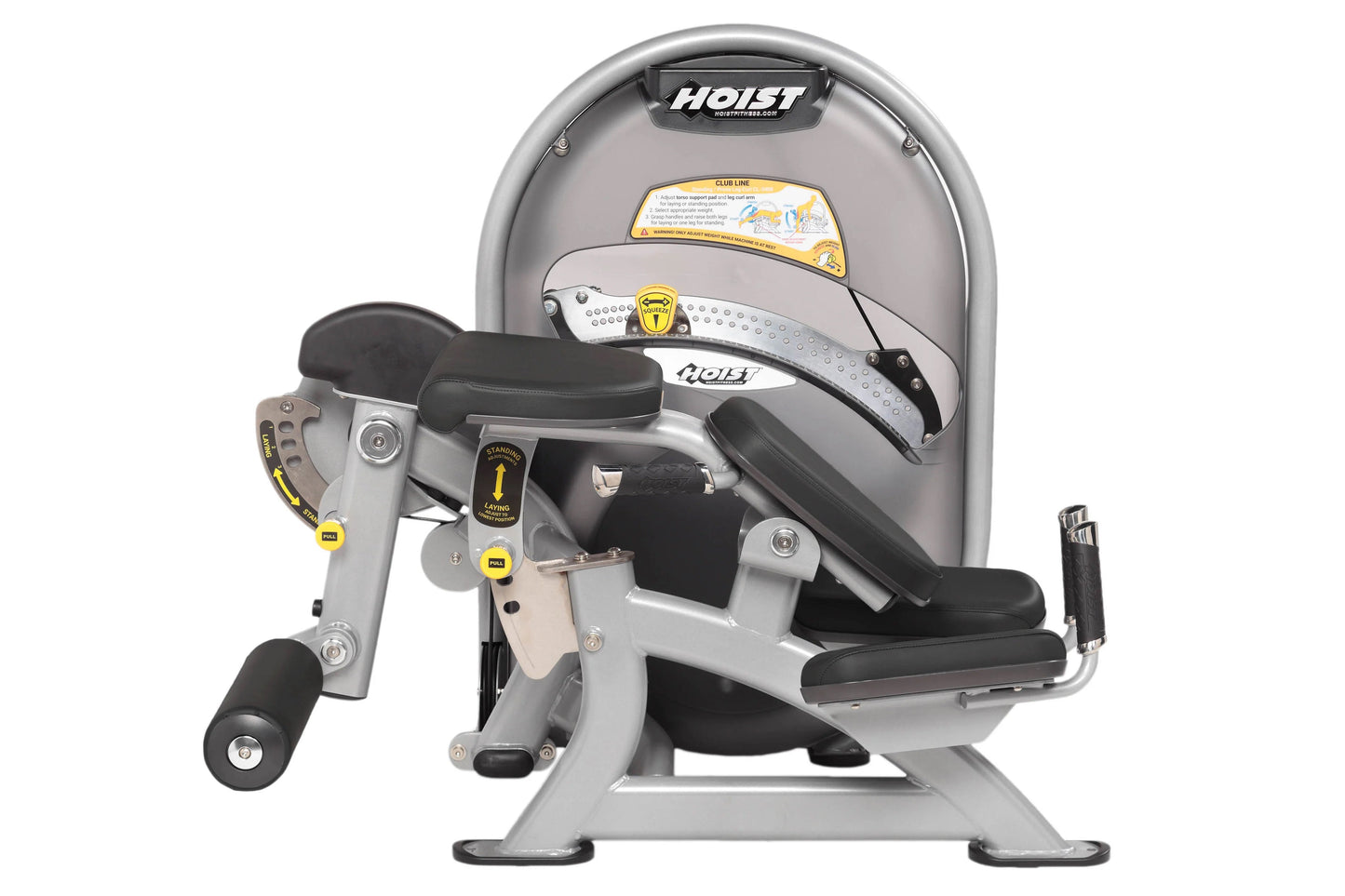 Hoist Standing Prone Leg Curl machine with gray frame, black padded seat and leg curl attachment, yellow safety labels, on wh