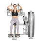 Woman using silver and gray abdominal exercise machine with weight stack, wearing black sports bra and lavender leggings