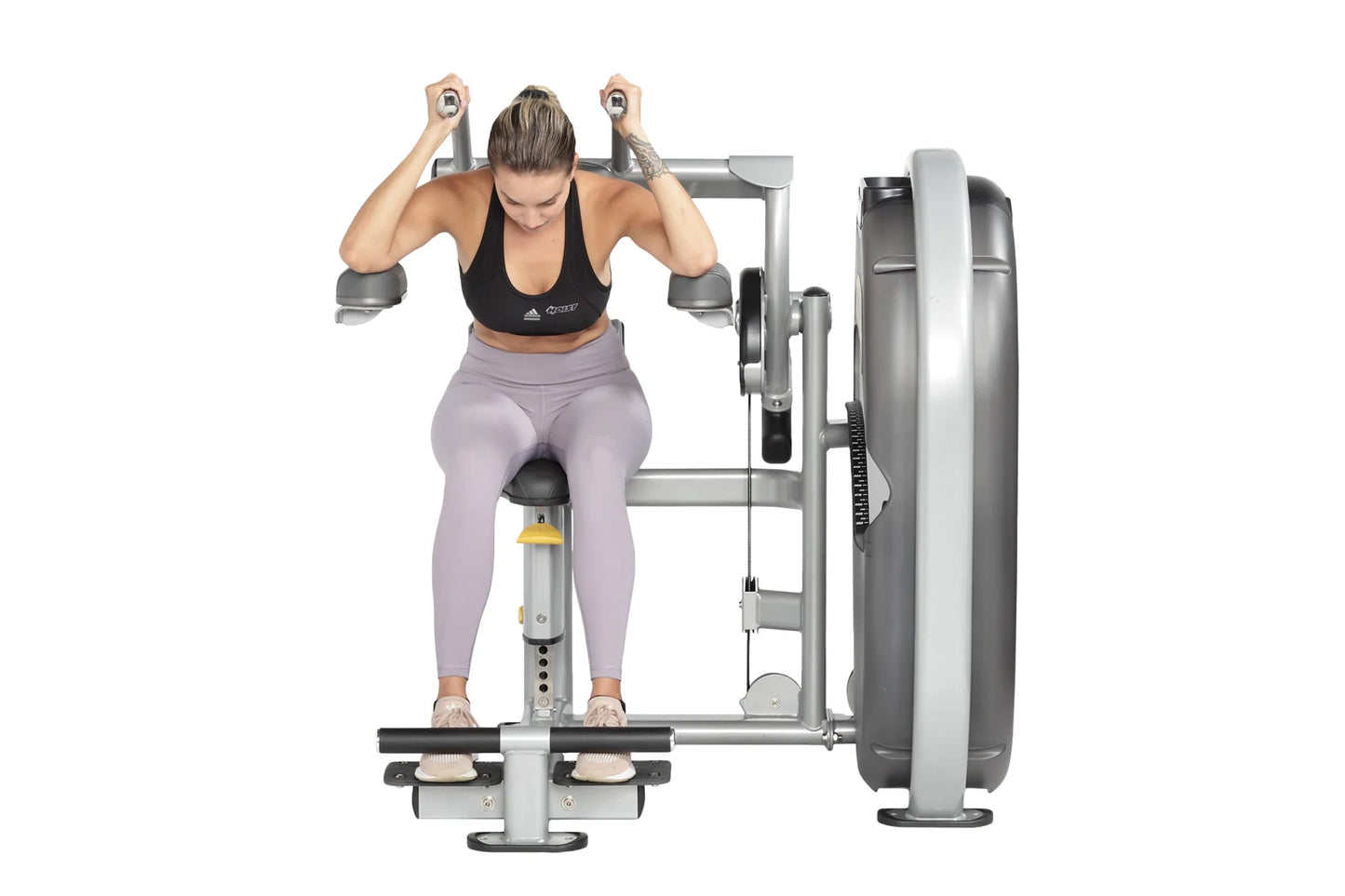 Woman performing abdominal exercise on Hoist Club Line leg press machine with silver frame and black seat, wearing black spor
