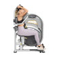 Woman using gray and black abdominal exercise machine with padded seat, arm handles, and foot platform on white background