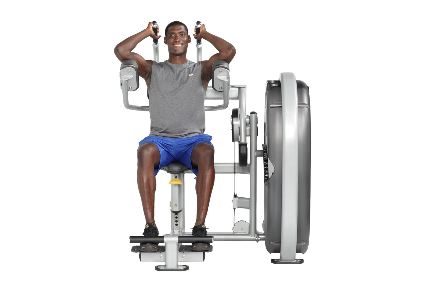 Man using gray and white Hoist Club Line abdominal machine, wearing gray t-shirt and blue shorts, demonstrating seated ab exe