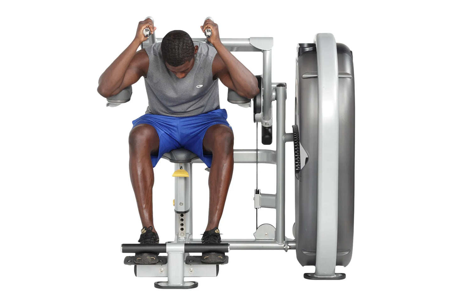 Man using gray and silver Hoist abdominal machine with blue shorts and gray tank top, front view against white background