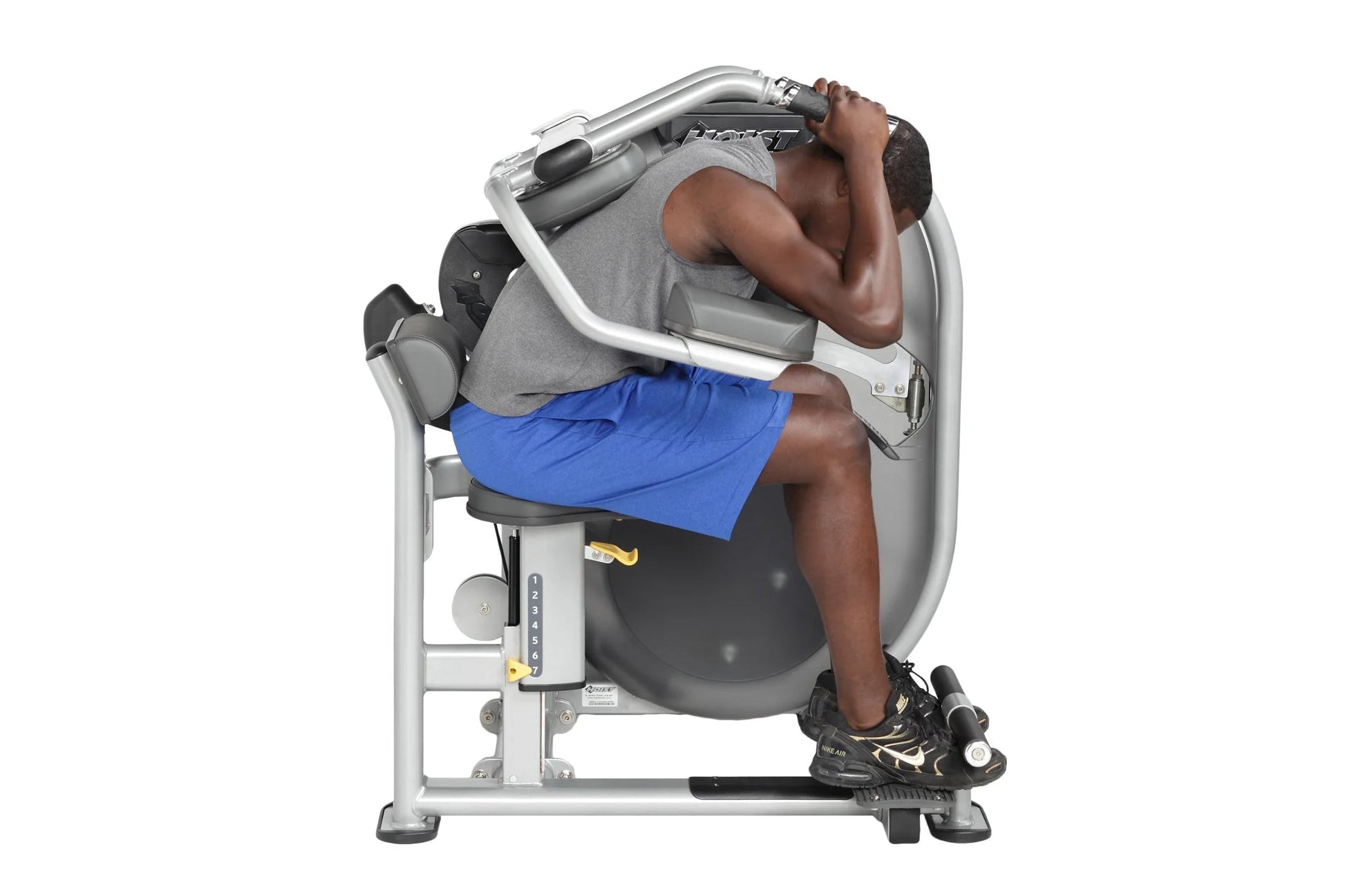 Man using Hoist Club Line abdominal machine with gray and white frame, performing seated crunch exercise