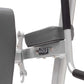 Hoist Fitness weight machine with gray padded seat back, silver metal frame, and black arm rest on white background