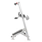 Silver and black leg press machine with adjustable seat, foot platform, and vertical frame on white background