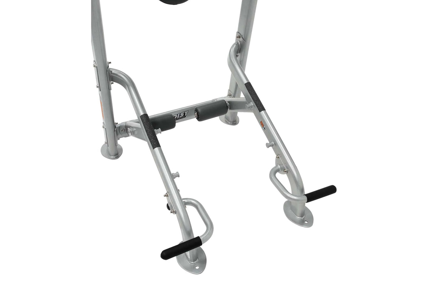 Silver metal home gym machine with black foam handlebars and foot pedals, flat lay on white background