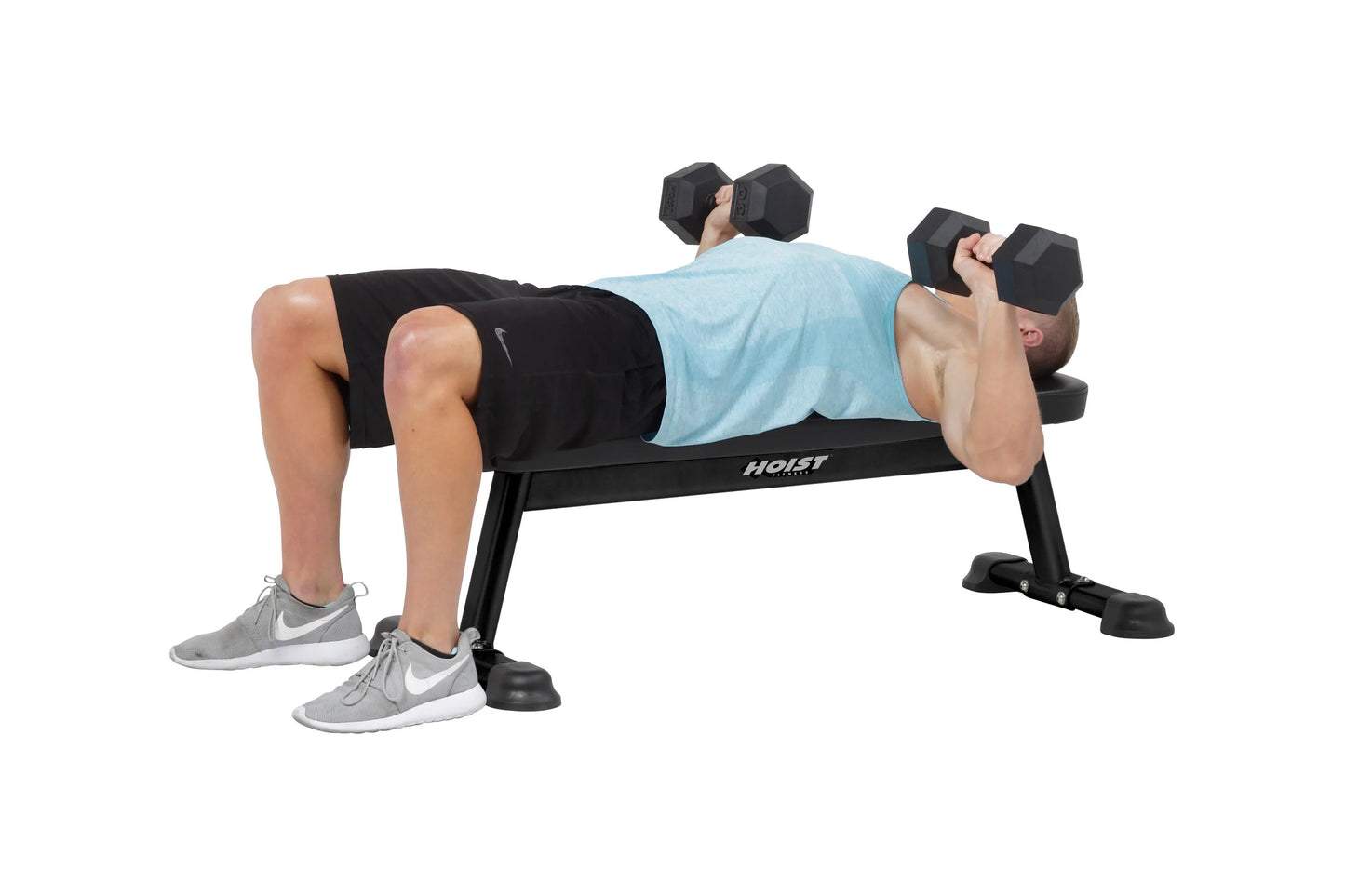 Man performing dumbbell chest press on black Hoist flat utility weight bench with adjustable seat