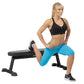 Model wearing black sports bra and bright blue shorts, demonstrating lunge exercise on Hoist flat utility bench with black fr