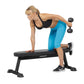 Woman performing dumbbell exercise on black Hoist flat utility bench, wearing blue capri leggings and black sports bra
