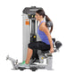 Woman using Hoist Ab Crunch exercise machine with gray and black frame, demonstrating seated abdominal workout position