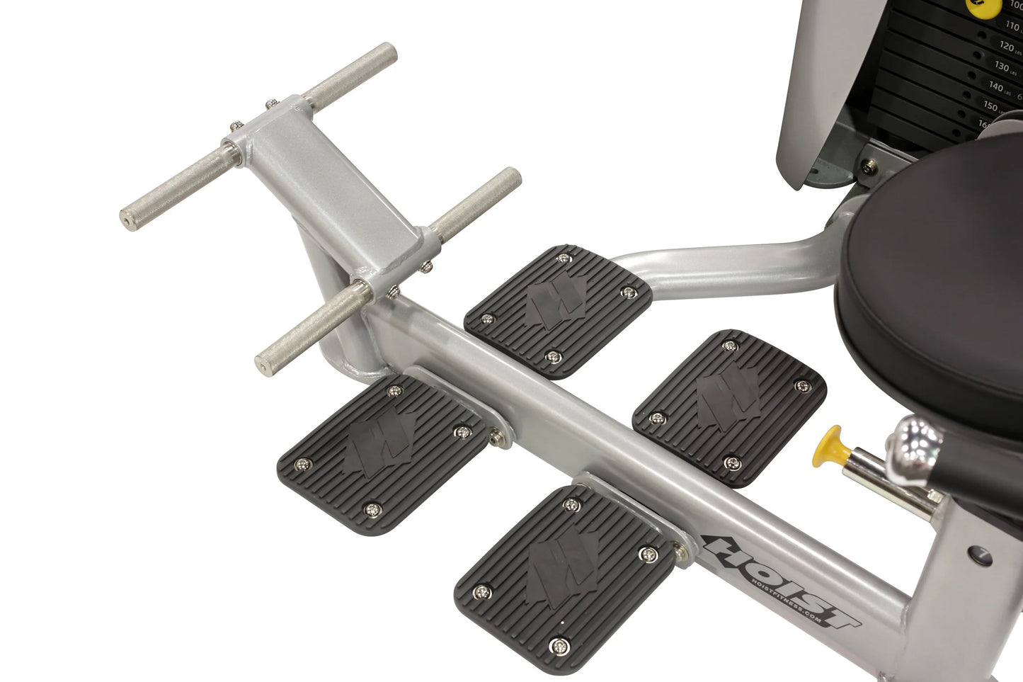 Hoist Ab Crunch/Low Back exercise machine with silver frame, black foot pedals, and handle bars on white background