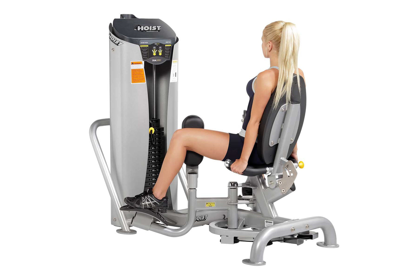Hoist Inner/Outer Thigh leg press machine with silver frame and black padded seat, demonstrated by woman in black athletic we