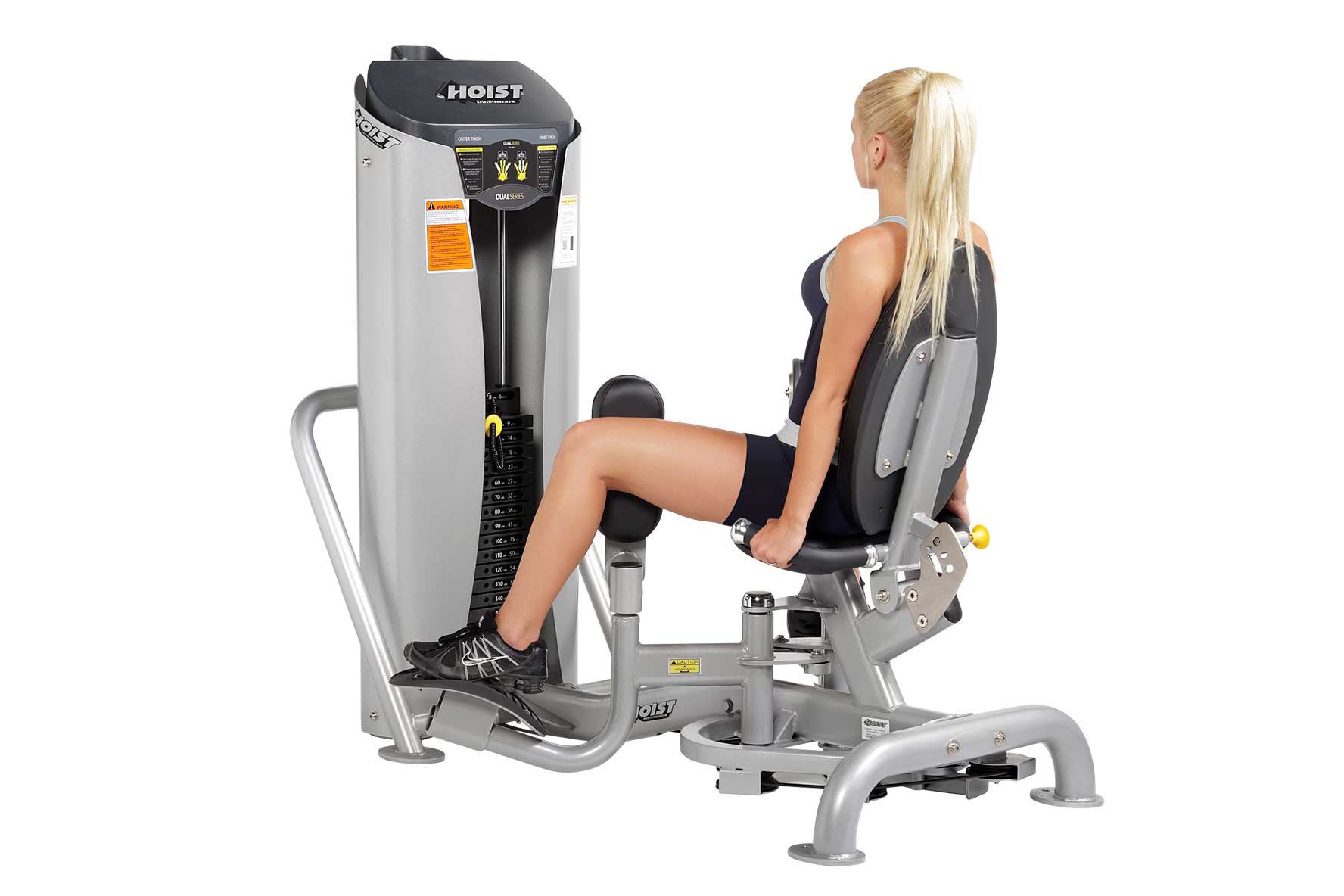 Hoist Inner/Outer Thigh leg press machine with silver frame and black padded seat, demonstrated by woman in black athletic we