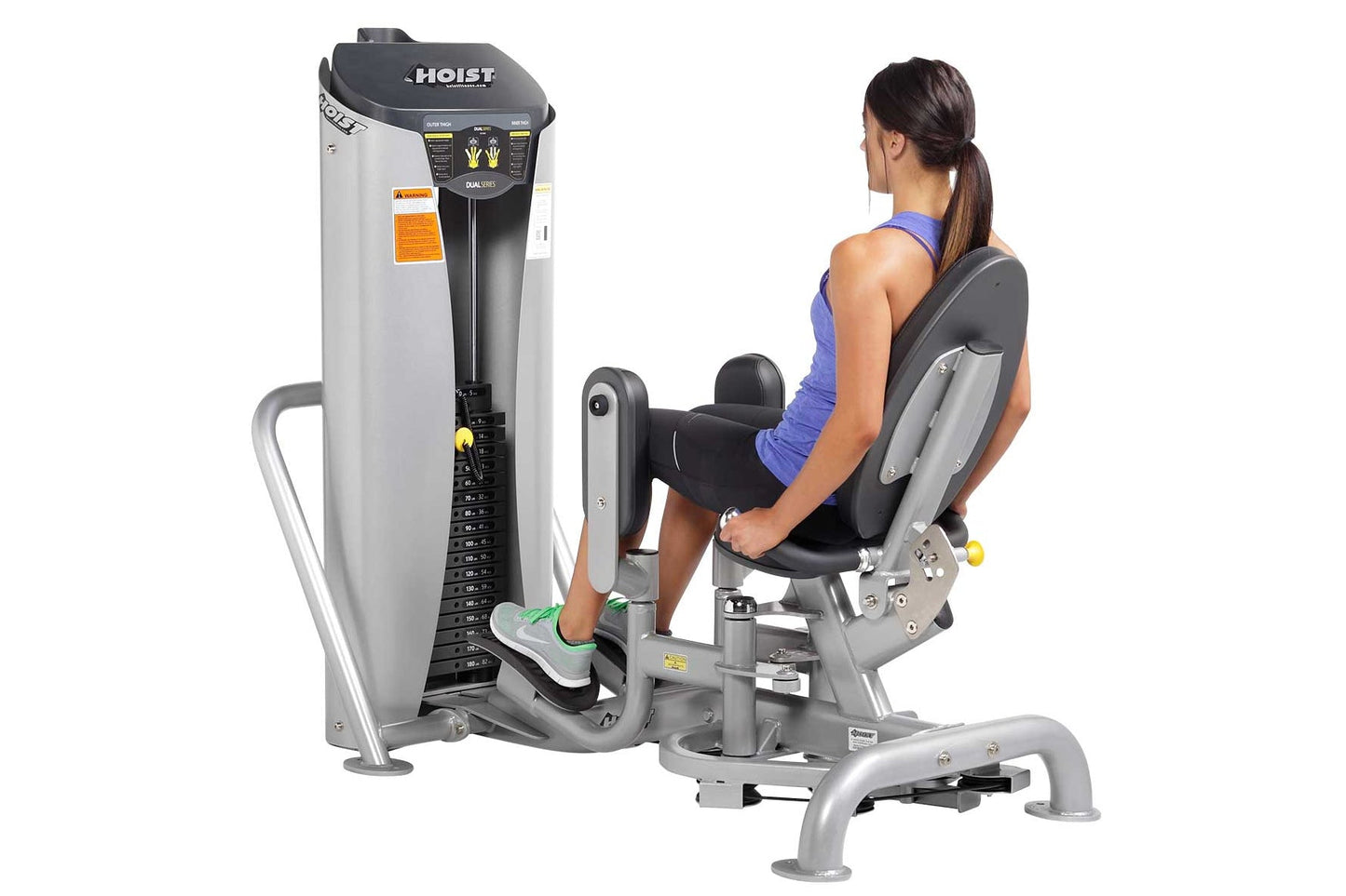 Woman in blue tank top seated on gray and black Hoist Inner/Outer Thigh leg press machine with dual lever controls