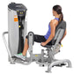 Woman using Hoist leg press machine with gray and black frame, worn by model in blue sports top on white background