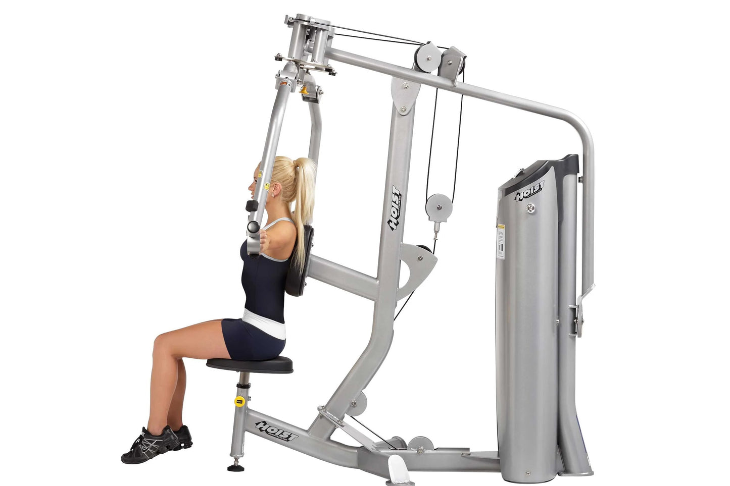 Woman using silver Hoist Pec Fly/Rear Delt machine with black seat, demonstrated on white background