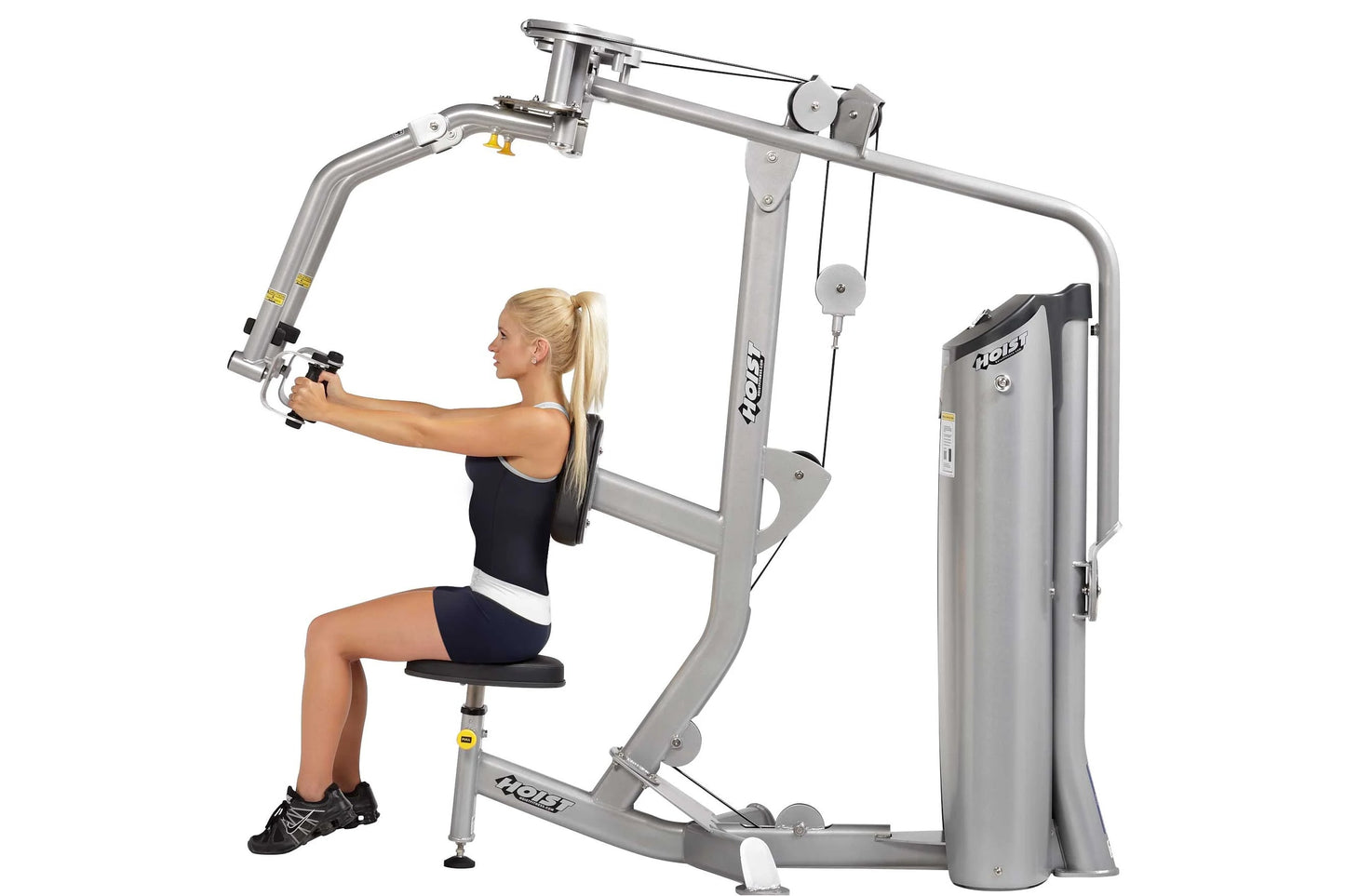 Woman using silver Hoist Pec Fly/Rear Delt exercise machine with adjustable arms and seat, demonstrating chest press position