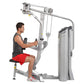 Man using silver Hoist Pec Fly/Rear Delt machine with cable arms, seated on black pad wearing gray tank top and red shorts