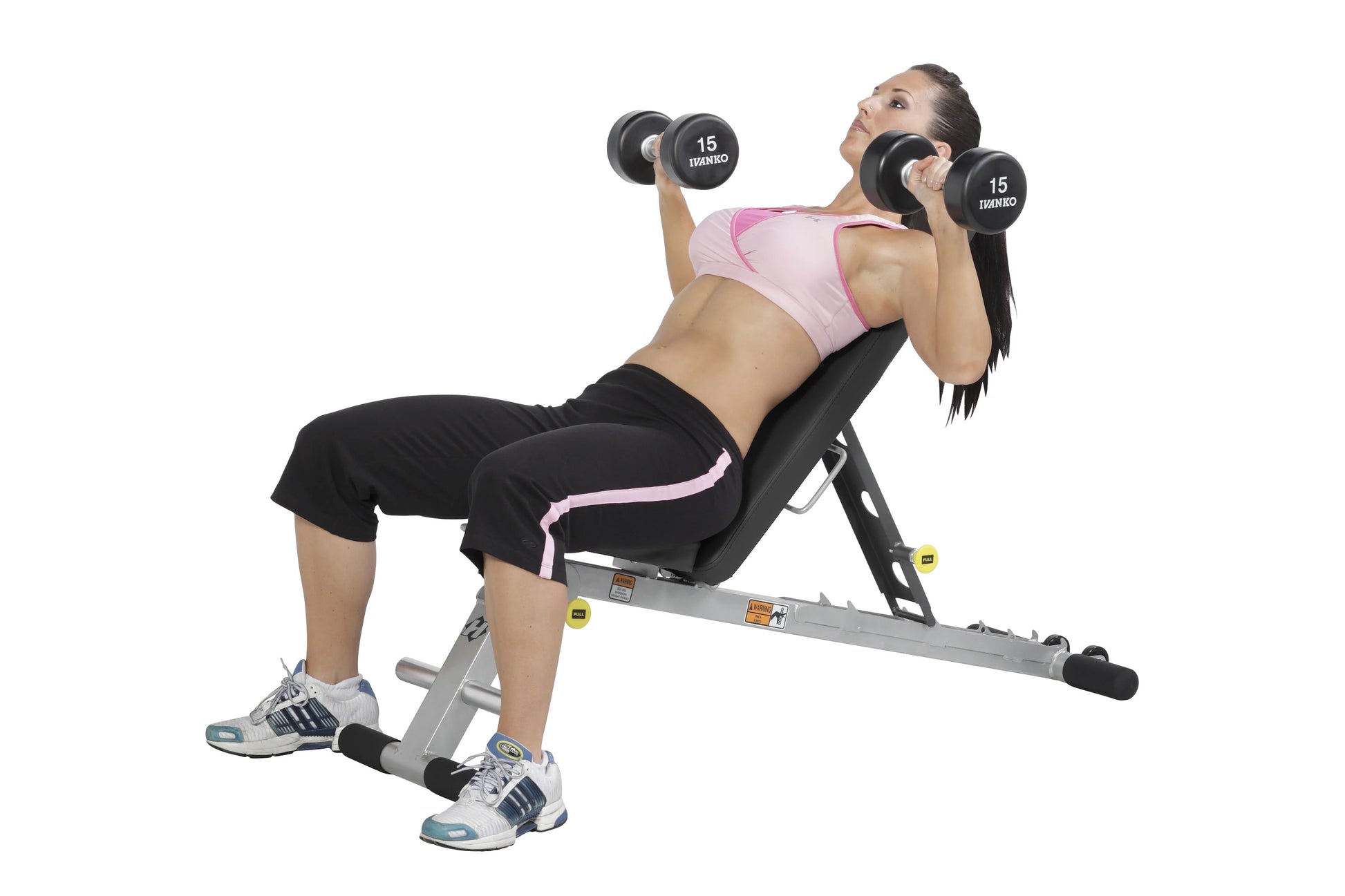 Woman performing dumbbell chest press on gray Hoist folding weight bench with pink accents, holding 15-pound dumbbells