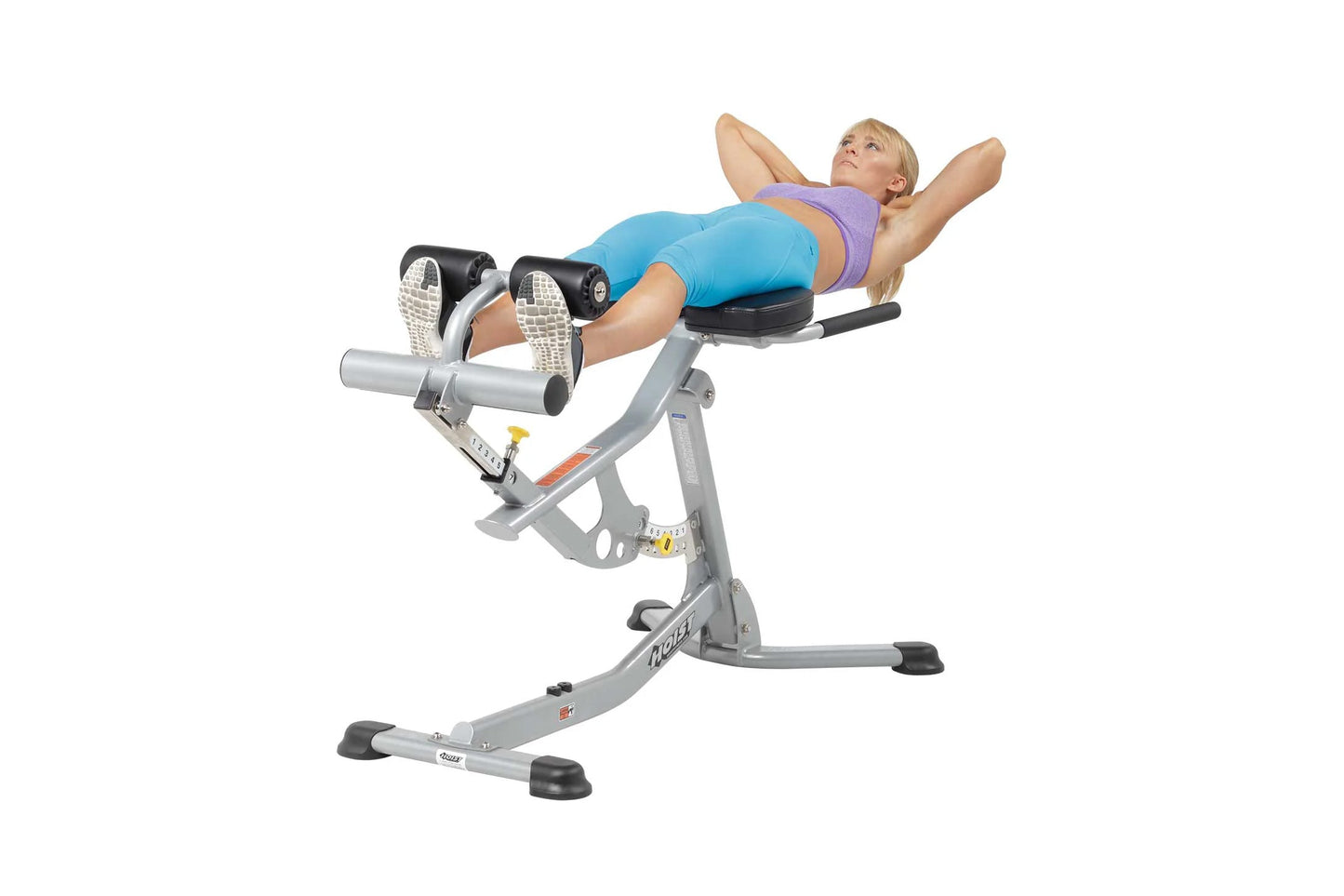 Woman using gray Hoist ab and back Roman hyperextension bench with adjustable leg extension, worn by model on white backgroun