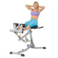 Woman using gray Hoist ab and back Roman hyper bench, wearing purple sports bra and blue leggings on white background