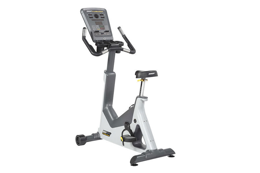 Hoist Lemond Series UC upright exercise bike with white frame, gray accents, digital console, and pedals on white background