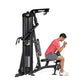 Black Hoist Mi1 home gym machine with user in pink shirt performing seated exercise, white background