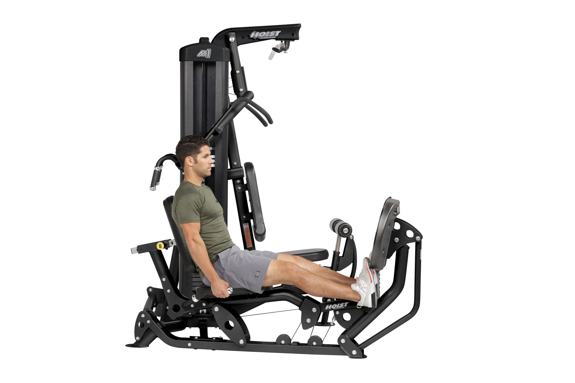 Hoist Mi1 black home gym machine with male model seated performing leg press exercise