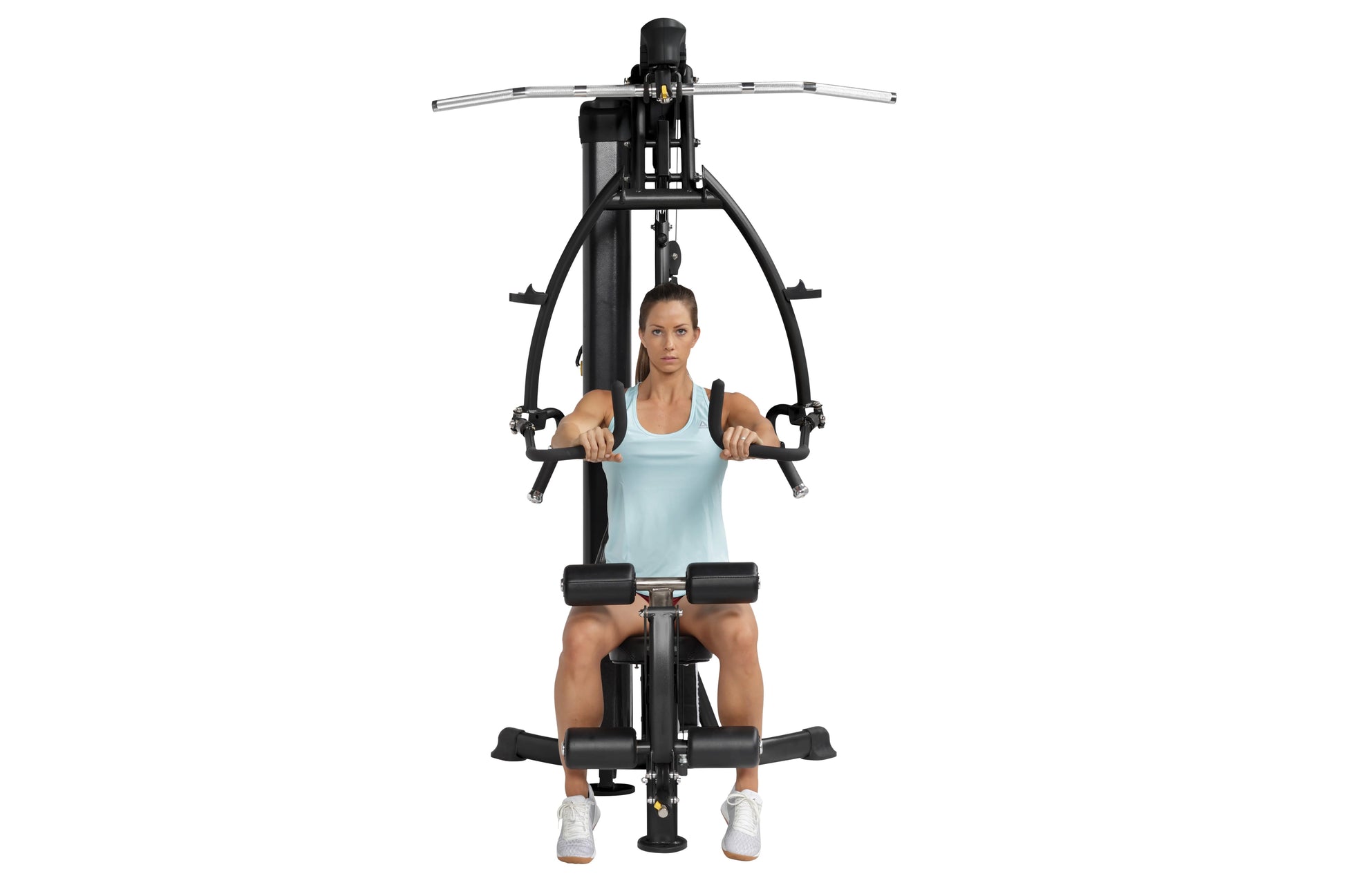 Black and silver home gym machine with chest press and leg press functions, model seated wearing light blue tank top and whit