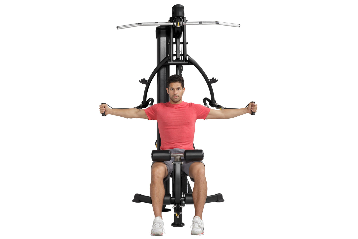 Man in red t-shirt using black Hoist Mi1 home gym machine with extended arms on white background