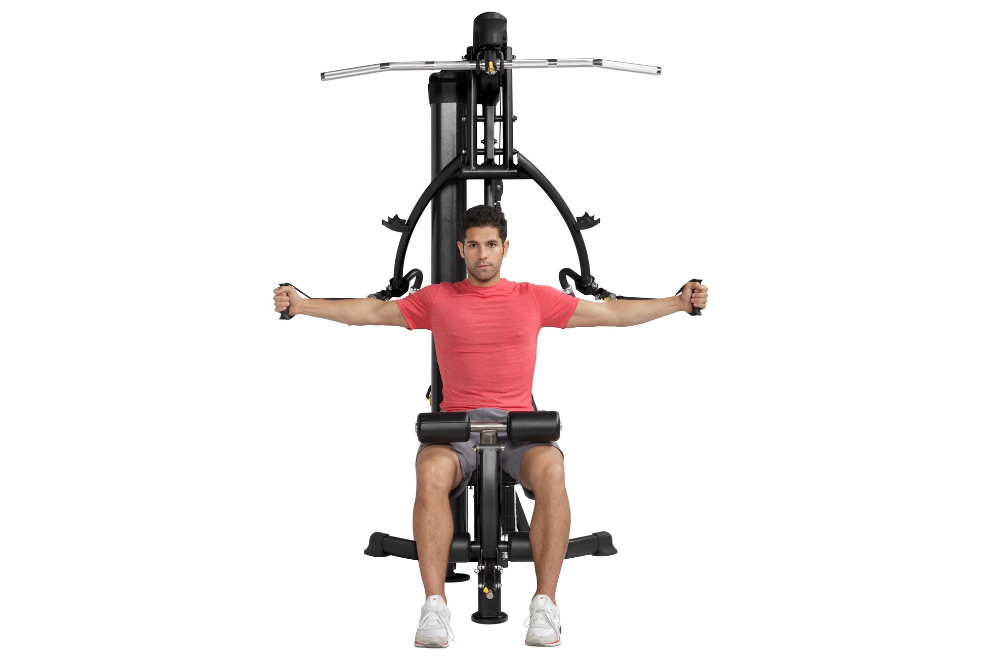 Man in red t-shirt using black Hoist Mi1 home gym machine with extended arms on white background