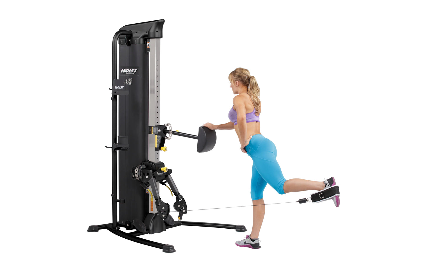Hoist Mi5 Functional Trainer with black and silver frame, model in use demonstrating leg exercise