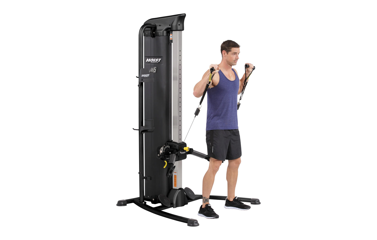Hoist Mi5 Functional Trainer with black and silver frame, worn by male model in purple tank top performing cable exercise