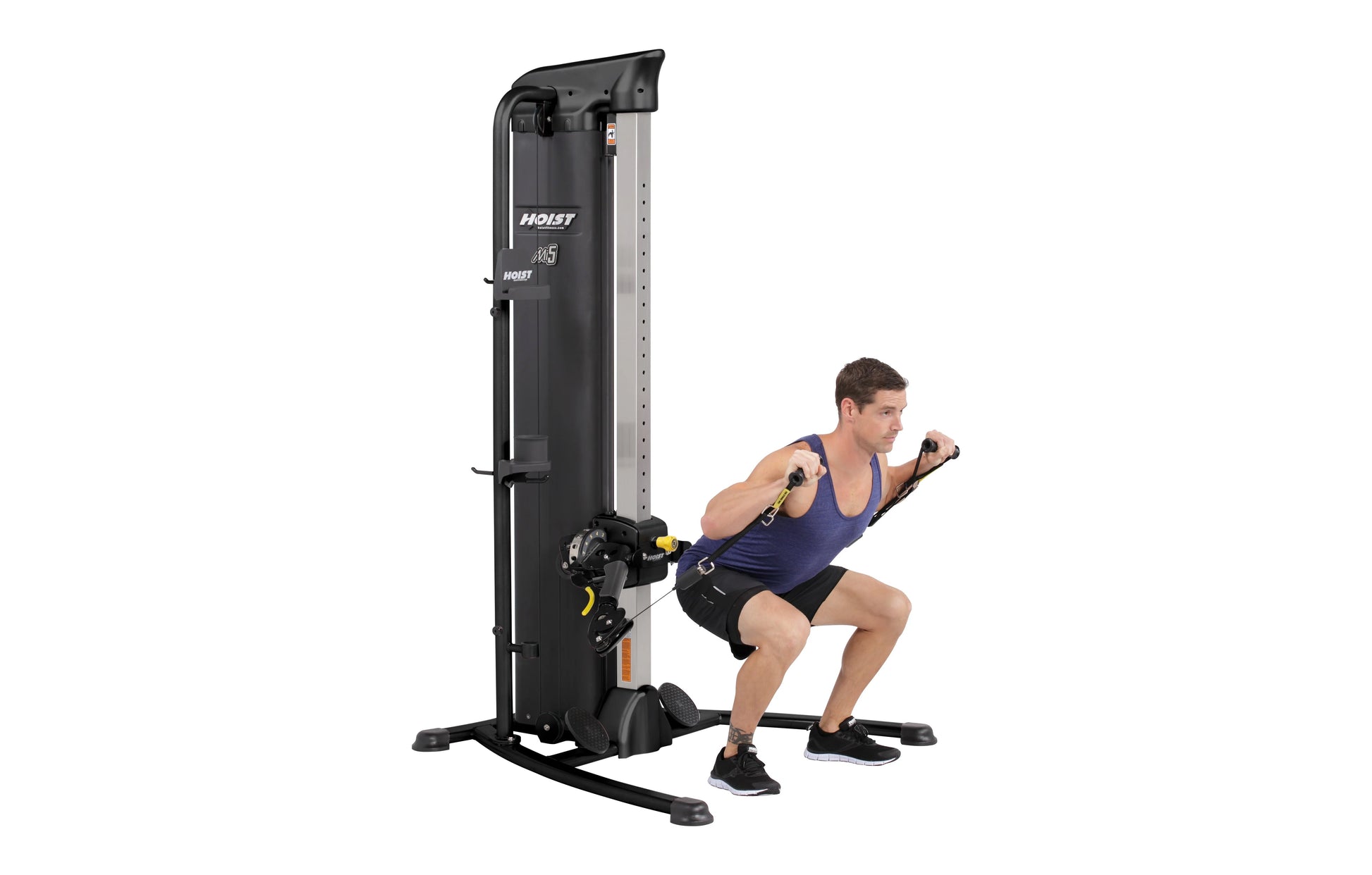 Hoist Mi5 Functional Trainer with black and silver frame, shown being used by male model performing chest fly exercise