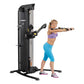 Hoist Mi5 Functional Trainer with black and silver frame, shown in use by female model in purple sports bra and blue capris