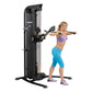 Hoist Mi5 functional trainer with black frame and gray accents, shown being used by a woman in purple sports bra and blue cap