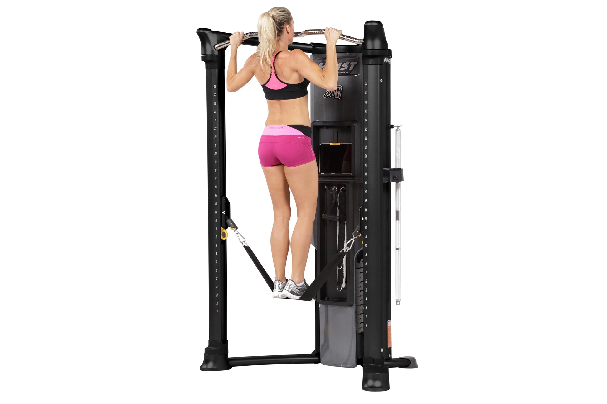 Black Hoist Mi6 functional trainer with model in pink sports bra and shorts performing lat pulldown exercise on white backgro