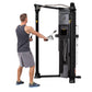 Man using black Hoist Mi6 functional trainer with cable system in gym setting