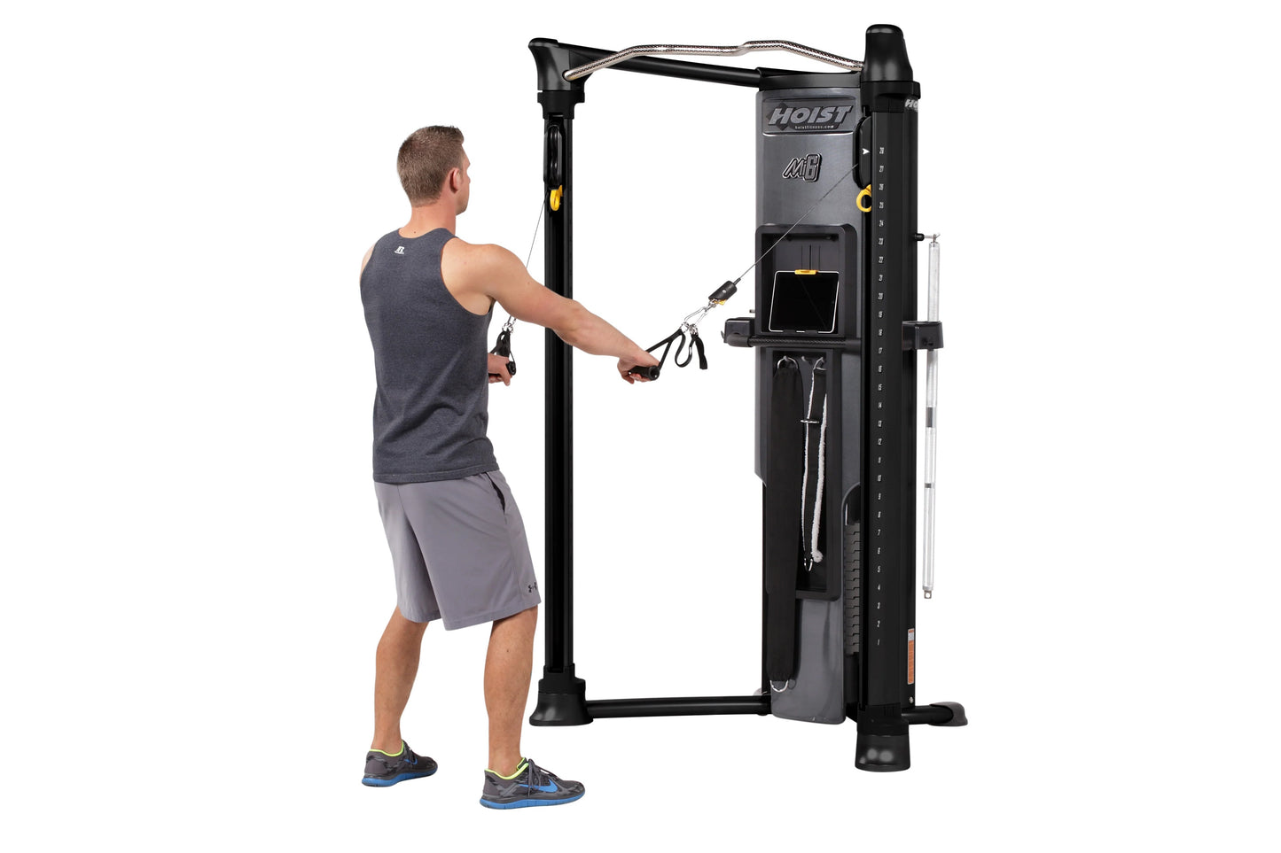 Man using black Hoist Mi6 functional trainer with cable system in gym setting