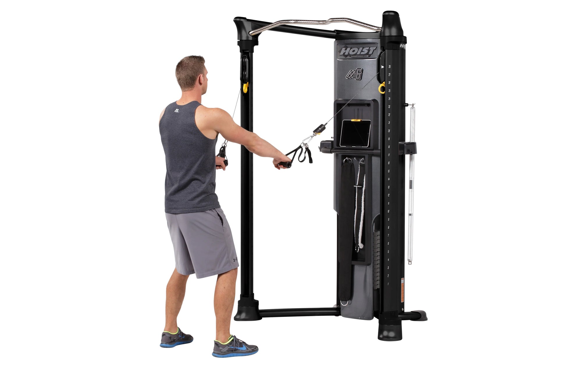 Man using black Hoist Mi6 functional trainer with cable system in gym setting
