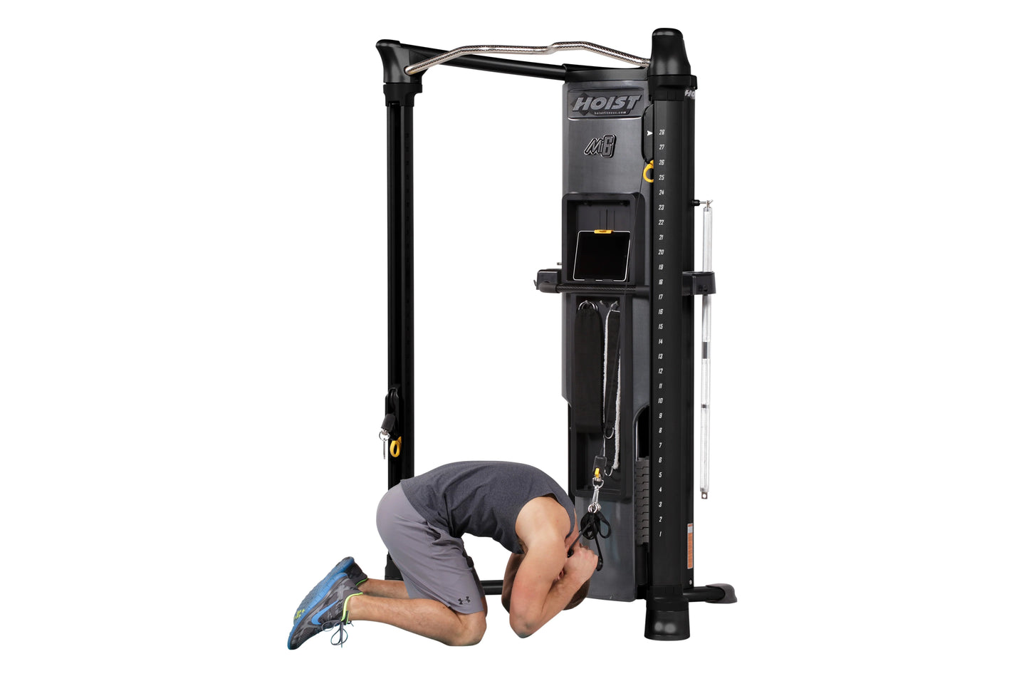 Hoist Mi6 black functional trainer home gym with model performing lat pulldown exercise on white background