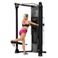 Woman using black Hoist Mi6 functional trainer machine with pink and black athletic wear, demonstrating leg press exercise on