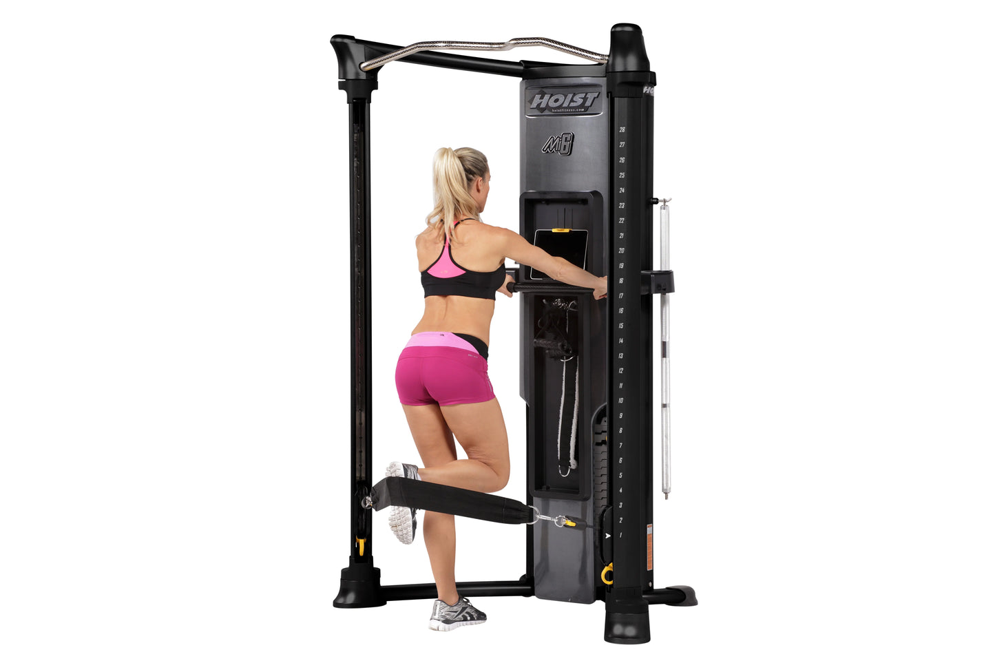 Black Hoist Mi6 functional trainer with cable machine and dual weight stacks, model demonstrating chest press exercise