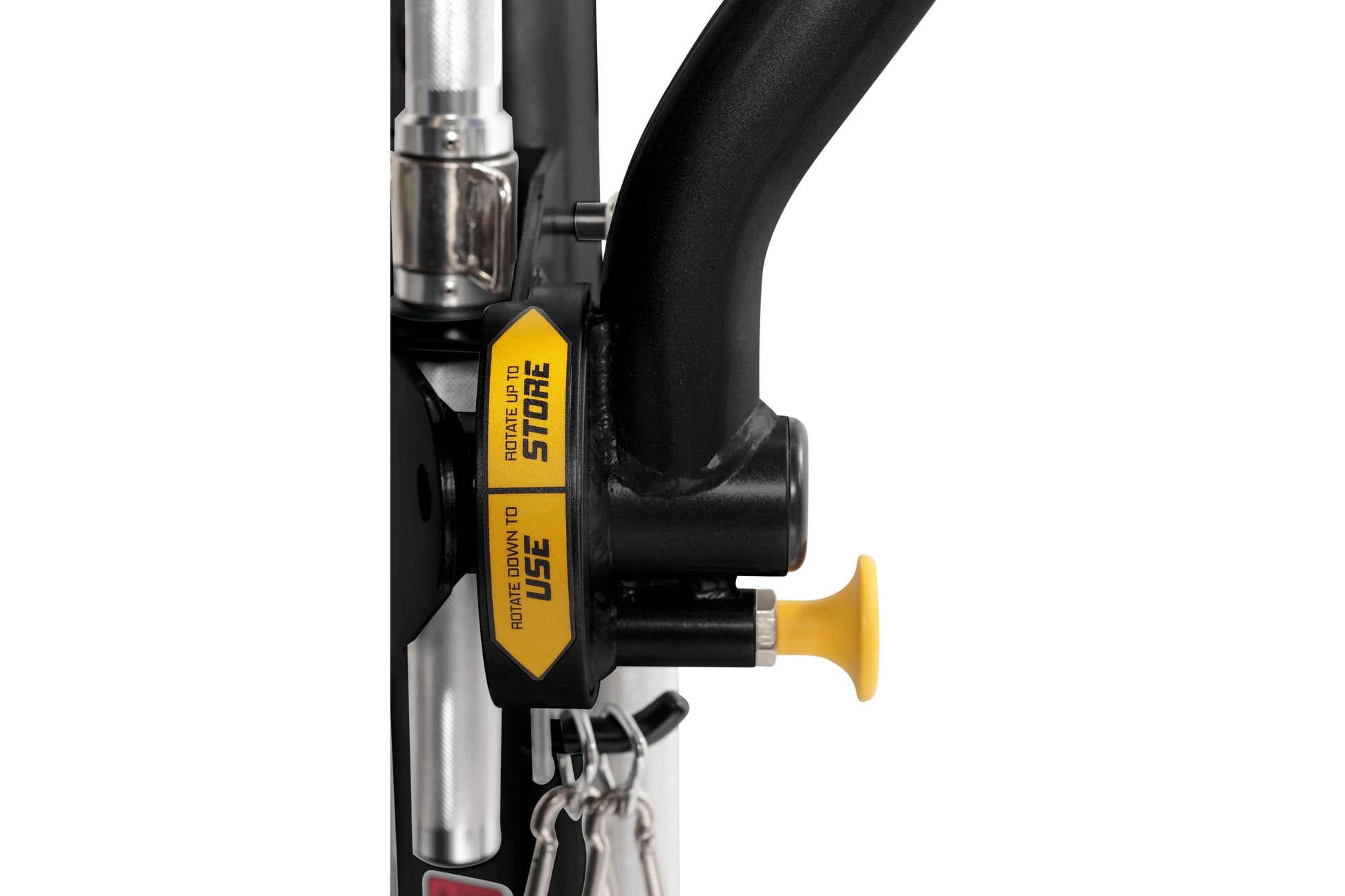 Black and silver functional trainer with yellow and black brakes labeled "rotate down to store" and "rotate down to use," sho