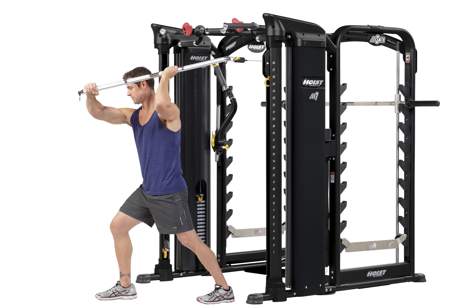Man using black Hoist MI7 functional trainer with cable attachment, demonstrating exercise form on white background