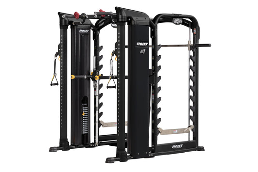 Hoist MI7 Smith functional trainer with black frame, cable stations with yellow pulleys, red adjustment knobs, and tan foot p