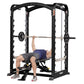 Black power rack smith machine with chrome barbell, worn by male model performing bench press exercise