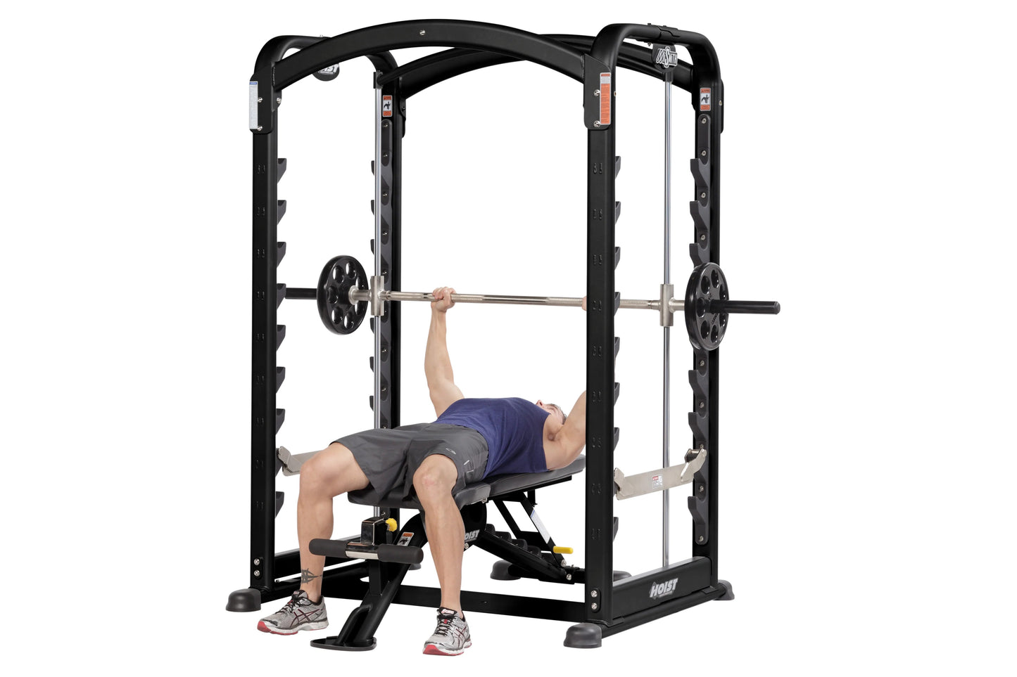 Black power rack smith machine with chrome barbell, worn by male model performing bench press exercise